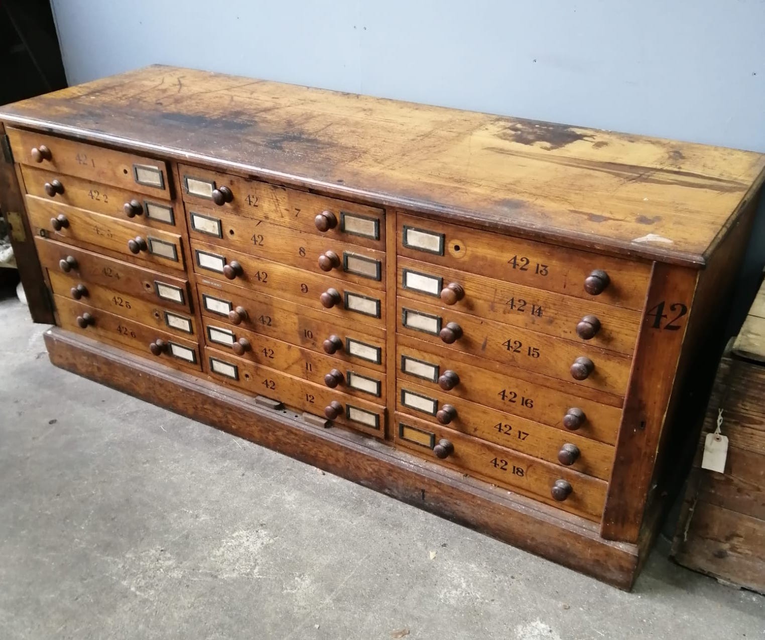 A large Victorian oak geological specimen cabinet, fitted 18 drawers with side locking bars, width 183cm, depth 63cm, height 77cm